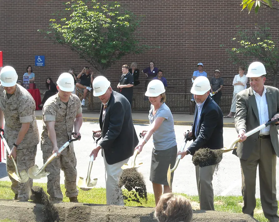 Several people in Stellar hard hats make a ceremonial dig with shovels.